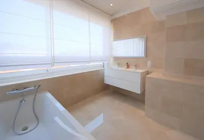 a bathroom with a tub and a sink at FOCH Bright prestigious apartment in Cannes ! in Cannes