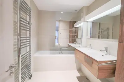 a bathroom with two sinks and a tub and a shower at GRAY Renovated luxurious apartment located in Cannes in Cannes