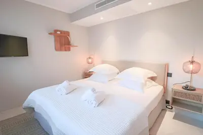 a bedroom with a white bed with white pillows at GRAY Renovated luxurious apartment located in Cannes in Cannes