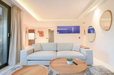 a living room with a couch and a table at GRAY Renovated luxurious apartment located in Cannes in Cannes