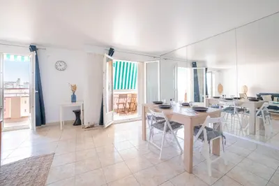 a room with a table and chairs and a dining room at Cannes Elegance – Balcony & Quiet Near Shops in Cannes