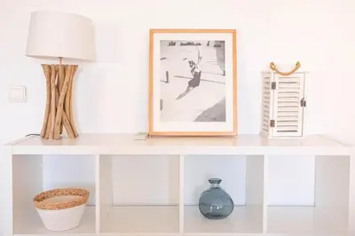 a white shelf with a picture and a lamp on it at Cannes Elegance – Balcony & Quiet Near Shops in Cannes
