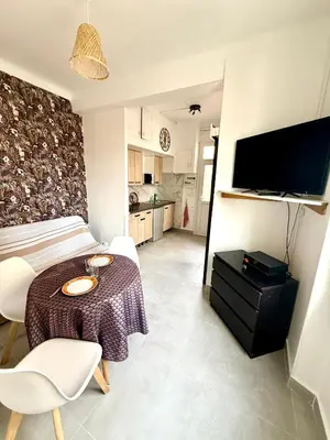 a coffee maker is sitting next to a microwave at Appartement WHITE DESIGN Proche Cannes in Le Cannet