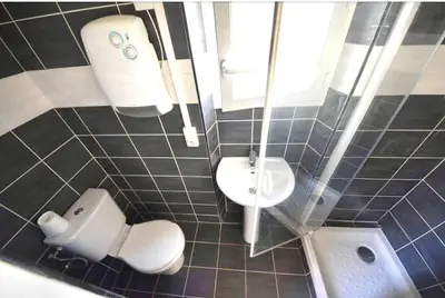 a small bathroom with a toilet and a sink at Appartement WHITE DESIGN Proche Cannes in Le Cannet