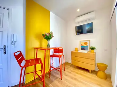 a room with a table and two chairs and a desk at Duplex Luxury Toîts du Soleil By SCLS Locations in Cannes