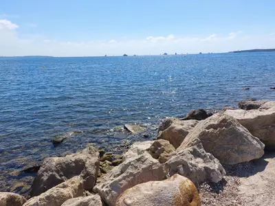 a group of rocks on the shore of a body of water at VILLA MAUPASSANT BORD DE MER in Cannes