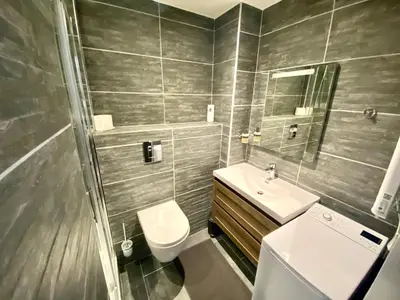 a bathroom with a sink and a toilet and a mirror at Le Marignan By SCLS Locations in Cannes