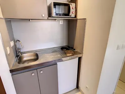 a small kitchen with a sink and a microwave at Studio Carré d'Or. 2 mins from the Croisette. 143 in Cannes
