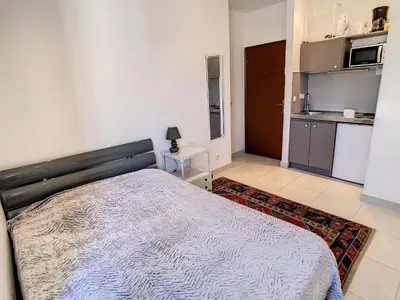 a bedroom with a bed and a kitchen at Studio Carré d'Or. 2 mins from the Croisette. 143 in Cannes