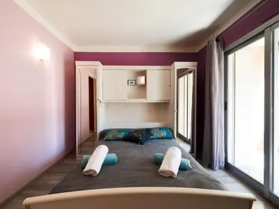 a bedroom with a large bed with two pillows at Apartment Le Morélia by Interhome in Cannes