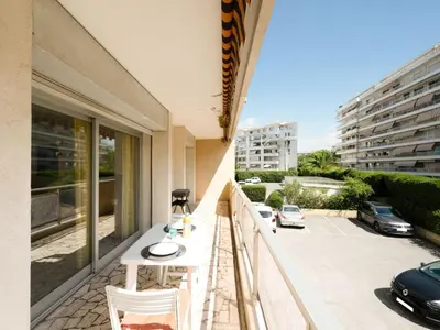 a balcony with a white table and chairs on it at Apartment Le Morélia by Interhome in Cannes