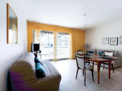 a living room with a couch and a table at Apartment Le Morélia by Interhome in Cannes