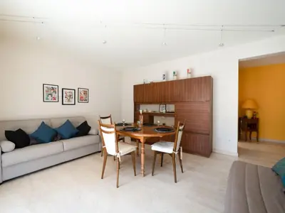 a living room with a couch and a table and chairs at Apartment Le Morélia by Interhome in Cannes