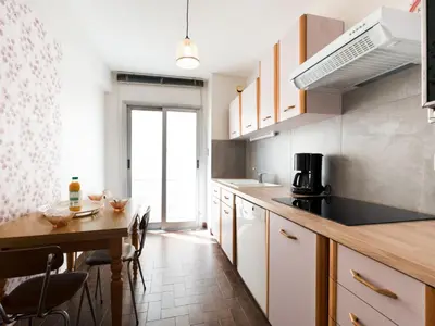 a kitchen with a table and a dining room at Apartment Le Morélia by Interhome in Cannes