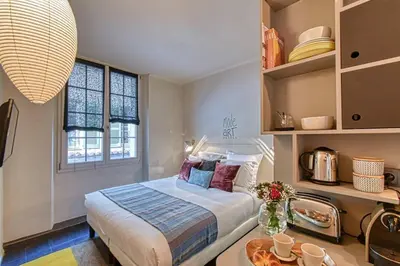 a bedroom with a bed and a table and a window at C074-Cannes Studio - Cannes Forville in Cannes