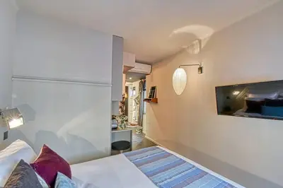 a bedroom with a bed and a tv on a wall at C074-Cannes Studio - Cannes Forville in Cannes
