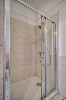 a shower with a glass door in a bathroom at Le Joy - Terrasse - Parking - Verrière Côte d'Azur in Cannes