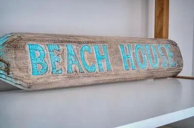 a sign that says beach house on top of a shelf at Le Joy - Terrasse - Parking - Verrière Côte d'Azur in Cannes
