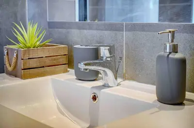 a bathroom sink with a faucet and a soap dispenser at Le Max et Leo - 600m plage - Verrière côte d'Azur in Cannes