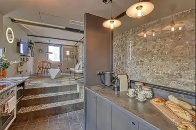 a kitchen with a counter and a stone wall at C075-Old Town Cannes - Duplex Apartment in Cannes