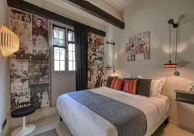 a bedroom with a large bed and posters on the wall at C075-Old Town Cannes - Duplex Apartment in Cannes