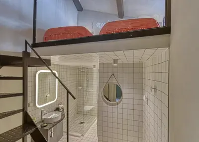 a room with a bunk bed and a bathroom at C075-Old Town Cannes - Duplex Apartment in Cannes