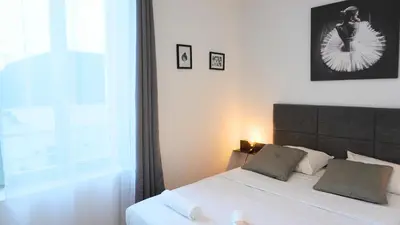 a bedroom with a bed with a large window at Proche Carlton & Croisette, Appartement 101 - Palmazur Vacances in Cannes