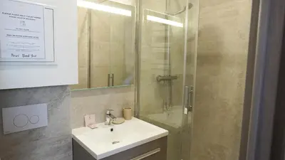 a bathroom with a sink and a shower at Proche Carlton & Croisette, Appartement 101 - Palmazur Vacances in Cannes