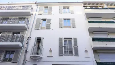 a white building with windows and balconies at Proche Carlton & Croisette, Appartement 101 - Palmazur Vacances in Cannes