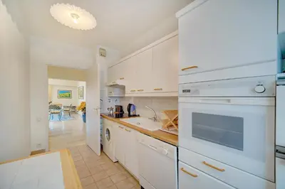 a kitchen with white cabinets and a stove top oven at 3 bedrooms in Cannes Center and south terrace in Cannes