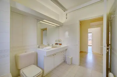 a white bathroom with a toilet and a sink at 3 bedrooms in Cannes Center and south terrace in Cannes