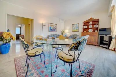a dining room with a glass table and chairs at 3 bedrooms in Cannes Center and south terrace in Cannes
