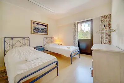 a bedroom with two beds and a window at 3 bedrooms in Cannes Center and south terrace in Cannes