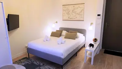 a bedroom with a bed with two pillows on it at Proche Carlton & Croisette, Appartement 103 in Cannes