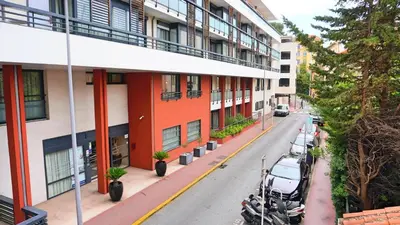an apartment building with motorcycles parked on a street at Proche Carlton & Croisette, Appartement 103 in Cannes