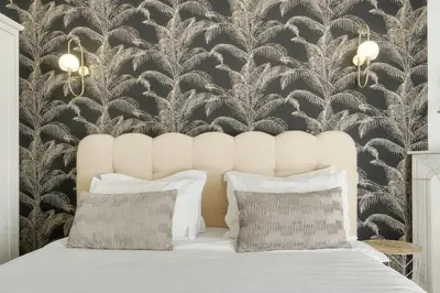 a bedroom with a white bed with a black and white wallpaper at Deja Blue - Beautiful 4 beds & 4 baths, 10min from Palais, 4 stars residence in Cannes