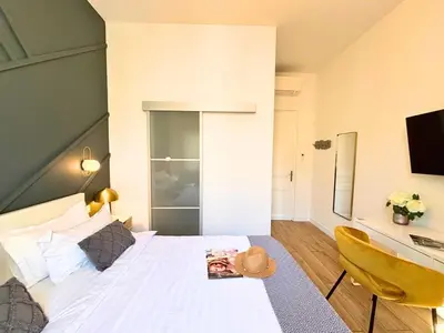 a bedroom with a white bed and a desk and a chair at Deja Blue - Beautiful 4 beds & 4 baths, 10min from Palais, 4 stars residence in Cannes