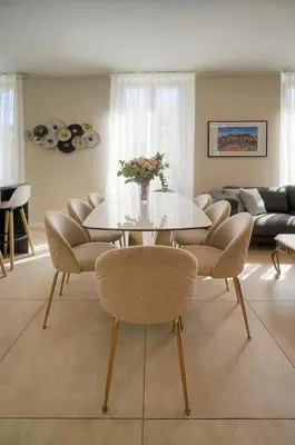 a living room with a table and chairs at Deja Blue - Beautiful 4 beds & 4 baths, 10min from Palais, 4 stars residence in Cannes