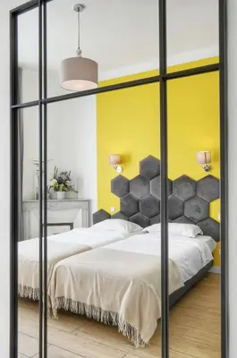 a bedroom with two beds and a yellow wall at Deja Blue - Beautiful 4 beds & 4 baths, 10min from Palais, 4 stars residence in Cannes