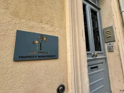 a sign on the side of a building with a door at Deja Blue - Beautiful 4 beds & 4 baths, 10min from Palais, 4 stars residence in Cannes