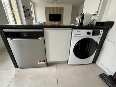 a kitchen with a microwave and a washing machine at Deja Blue - Beautiful 4 beds & 4 baths, 10min from Palais, 4 stars residence in Cannes