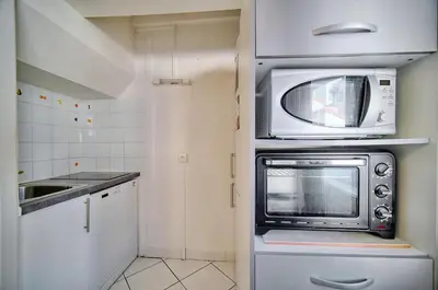 a small kitchen with a microwave and a sink at Confortable 2 pièces, HYPER CENTRE- CENTRE VILLE A1B237 in Cannes