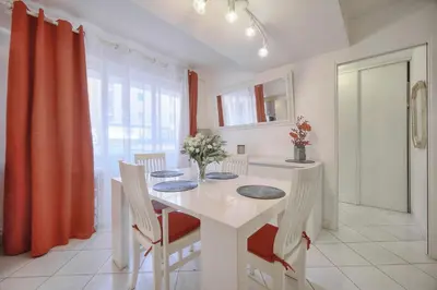 a white dining room with a white table and chairs at Confortable 2 pièces, HYPER CENTRE- CENTRE VILLE A1B237 in Cannes