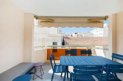 a blue table and chairs on a balcony at Blue Bay in Cannes