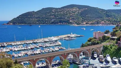 a bridge over a marina with boats in the water at Proche Carlton & Croisette, Appartement 203 - Palmazur Vacances in Cannes