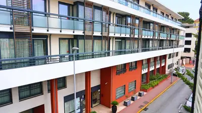 an apartment building with balconies and a street at Proche Carlton & Croisette, Appartement 203 - Palmazur Vacances in Cannes