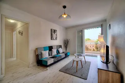 a living room with a couch and a window at IMMOGROOM - Fully equipped - Terrace with sea view - AC in Cannes