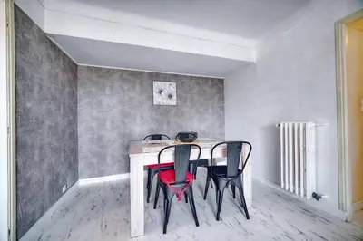 a dining room table with three chairs in a room at IMMOGROOM - Fully equipped - Terrace with sea view - AC in Cannes