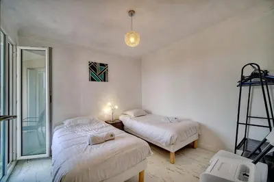 a bedroom with two beds and a ladder in it at IMMOGROOM - Fully equipped - Terrace with sea view - AC in Cannes