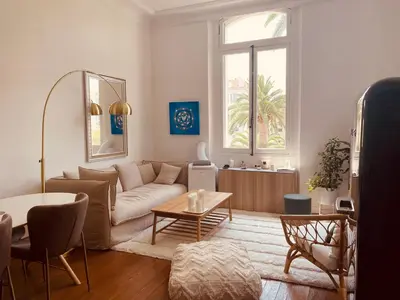 a living room with a couch and a table at superbe appartement centre Cannes in Cannes